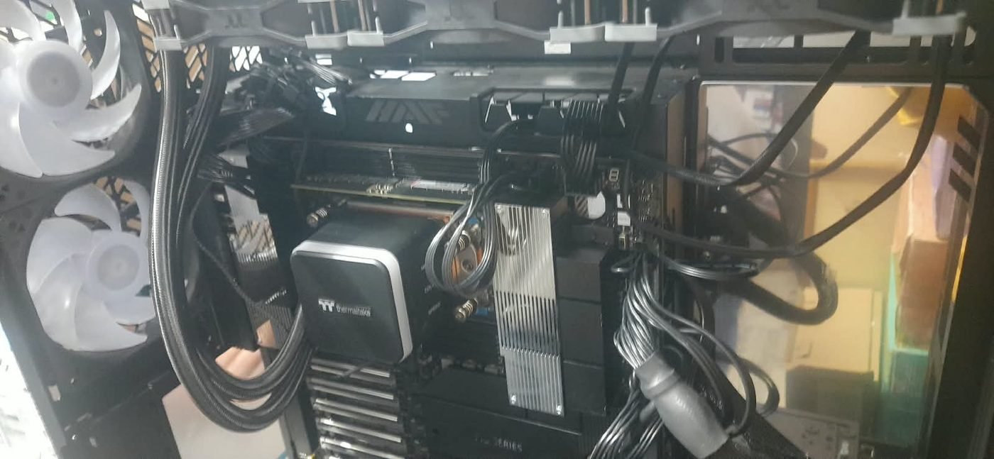 Inside the workstation: workstation-class motherboard, Thermaltake liquid CPU cooler and braided power cables